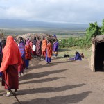 Maasai people and the entrance to a house