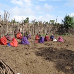 Women sitting in the corral, chatting and making jewerly