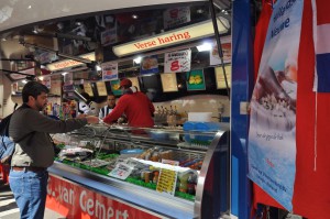 Curtis buying the herring at a sidewalk stand 